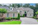 Stunning brick home with manicured landscaping and a beautiful stone driveway at 8230 Royal Melbourne Way, Duluth, GA 30097