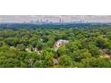 Beautiful home nestled amongst lush trees with city skyline in background at 91 Rogers Se St, Atlanta, GA 30317