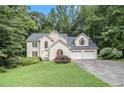 Charming two-story stucco home with a well-manicured lawn and an attached two-car garage at 3420 Cranborne, Marietta, GA 30062