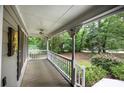 Inviting front porch with decorative railing and ceiling fan, perfect for relaxing at 131 Banyon Ct, Dallas, GA 30157