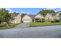 A single-story home with a well-manicured lawn, two car garage, and classic suburban appeal at 2397 Cove Lake Rd, Lithonia, GA 30058
