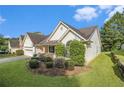 A charming single-story home featuring an attached two-car garage and lush, manicured landscaping at 2397 Cove Lake Rd, Lithonia, GA 30058
