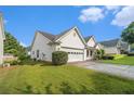 The home has a well-manicured lawn, a two-car garage, and tidy landscaping at 2397 Cove Lake Rd, Lithonia, GA 30058