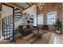 Inviting living room features exposed brick wall, spiral staircase, and a comfortable seating area at 63 Mangum Sw St # 3, Atlanta, GA 30313