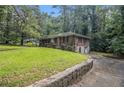 An eye-level view of this brick home showing the side yard, a partial view of the backyard, and a one car garage at 1206 Tuckawanna Sw Dr, Atlanta, GA 30311