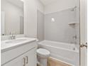 Well-lit bathroom with a combined shower and tub, gray tiling, and a modern vanity with countertop at 1991 Deco Dr, Kennesaw, GA 30144
