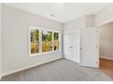 Inviting bedroom with plush carpet, a large window with scenic views, and a spacious double-door closet at 1991 Deco Dr, Kennesaw, GA 30144