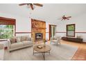 Neutral staged living room showcases stone fireplace, hardwood-style floors, and comfortable seating at 2419 Anderson Mill Rd, Austell, GA 30106
