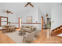 Bright, staged living room with hardwood-style floors, dining area, neutral furniture, and stairs at 2419 Anderson Mill Rd, Austell, GA 30106