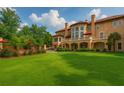 Lush backyard with manicured lawn and a covered patio for elegant outdoor entertaining at 720 Heards Ferry Rd, Sandy Springs, GA 30328