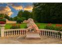 Beautifully landscaped grounds with a stately lion statue and manicured greenery at 720 Heards Ferry Rd, Sandy Springs, GA 30328
