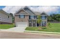 Spacious two-story brick house with a lush green lawn, offering a modern and comfortable living space at 1816 Kingsmere Run Dr, Loganville, GA 30052