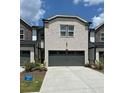 Brick exterior with a two-car garage and well-maintained landscaping at 2670 Greenbelt Rd, Snellville, GA 30078