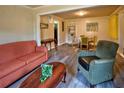 Living room featuring updated vinyl floors, sofa, and armchair set near a dining area at 2958 Klondike Rd, Lithonia, GA 30038