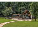Outdoor entertaining area with stone fireplace, pergola, and ample seating at 450 Dorset Sw Way, Smyrna, GA 30082