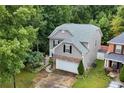 Aerial view of gray home showing landscaping and driveway at 2468 Whistle Stop Dr, Norcross, GA 30071