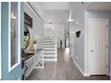 Bright and airy foyer with staircase, wood floors and a pop of color in the custom blue front door at 3568 Foxworth Ct, Buford, GA 30519