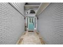 Elegant blue front door framed by a gray brick facade and decorative brickwork welcomes you home at 3568 Foxworth Ct, Buford, GA 30519