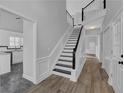 Inviting entryway with staircase, modern design, and access to kitchen and other rooms at 5696 Kilrush Se Ct, Mableton, GA 30126