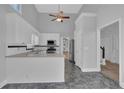 Bright, modern kitchen with white cabinets, gray countertops, and stainless steel appliances at 5696 Kilrush Se Ct, Mableton, GA 30126
