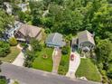 An aerial view of three homes showcasing their well-manicured lawns and neighborhood at 2355 Ewing Ne Dr, Brookhaven, GA 30319