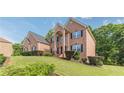 Brick home with green lawn, manicured bushes, and traditional architectural details, creating a welcoming curb appeal at 3202 Lucky Pl, Conyers, GA 30013