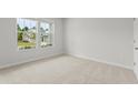 Neutral bedroom with carpet and windows providing natural light at 2529 Brown Dove Way (Lot 80), Grayson, GA 30017