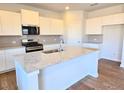 Bright kitchen features granite countertops, stainless appliances, and ample cabinet space at 2539 Brown Dove Way(Lot 81), Grayson, GA 30017