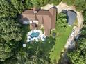 Stunning aerial view of a large house with a private backyard, pool, patio, and ample parking space at 3355 Old Peachtree Rd, Dacula, GA 30019
