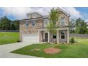 New two-story brick home with an attached two-car garage and a concrete driveway on a grass lot at 1797 Kingsmere Run Dr, Loganville, GA 30052