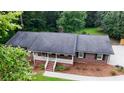 An elevated shot of the beautiful brick home with a well-maintained roof, porch, and landscaping at 2202 Springdale Dr, Snellville, GA 30078