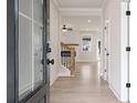 Inviting foyer with light wood floors leading to a living space featuring a staircase and an open floorplan at 722 Crossroad Ct, Powder Springs, GA 30127