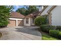 Attached two car garage with concrete driveway and manicured bushes at 2050 Trotters Ridge Way, Roswell, GA 30075