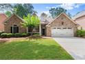 Charming brick home with manicured lawn and two-car garage at 1065 Beacon Hill Xing, Alpharetta, GA 30005