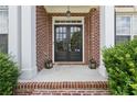 Elegant double front doors framed by brick columns with detailed trim and decor at 2444 Mossy Branch Dr, Snellville, GA 30078