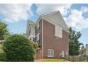 Side view of the brick home, showing the architectural design and the surrounding yard at 2444 Mossy Branch Dr, Snellville, GA 30078