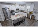 Beautiful kitchen with a large island, stainless steel appliances, white cabinets, and granite countertops at 3227 Hidden Valley Cir, Lawrenceville, GA 30044