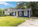 Bungalow style home featuring a well-kept lawn and visible concrete driveway at 971 Sims Nw Ave, Atlanta, GA 30318