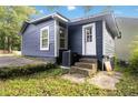 Home's exterior showcasing backyard access with an AC unit and concrete steps at 971 Sims Nw Ave, Atlanta, GA 30318