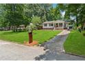 Street view of cozy home featuring lush lawn, driveway, and mature shade trees at 1978 Ethel Ln, Decatur, GA 30032