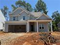 Charming two-story home with an unfinished landscape and visible garage at 340 Bloomfield Cir, Canton, GA 30114