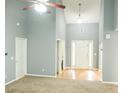 Open living space with vaulted ceilings, natural light, and neutral color scheme; ready for personalization at 85 Lamar Ln, Covington, GA 30016