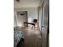 A bedroom with hardwood floors, a large window and closet space at 4876 Velva Nw Way, Lilburn, GA 30047