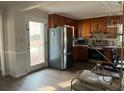 Cozy kitchen with stainless steel appliances, wood cabinets, and an exterior door at 4876 Velva Nw Way, Lilburn, GA 30047