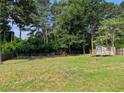 Large backyard with trees and a storage shed at 1041 Waverly Drive Dr, Lawrenceville, GA 30046