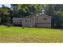 Back exterior view of the house with a deck overlooking the lawn at 1041 Waverly Drive Dr, Lawrenceville, GA 30046