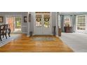 Inviting entryway with hardwood floors flowing into a carpeted formal living space with large windows at 1170 Shellnut Trl, Hoschton, GA 30548