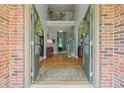 Bright foyer with hardwood floors and a staircase leading to an open second-story landing at 1170 Shellnut Trl, Hoschton, GA 30548