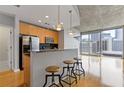 Modern kitchen with stainless steel appliances and a breakfast bar overlooking city views at 400 W Peachtree St # 2108, Atlanta, GA 30308
