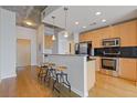 Modern kitchen with stainless steel appliances and a breakfast bar with seating at 400 W Peachtree St # 2108, Atlanta, GA 30308